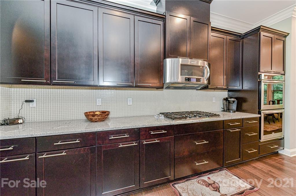 2756 Collaroy Road Waxhaw, NC 28173 - Photo 12 of 48 a kitchen with stainless steel appliances granite countertop a sink stove and cabinets