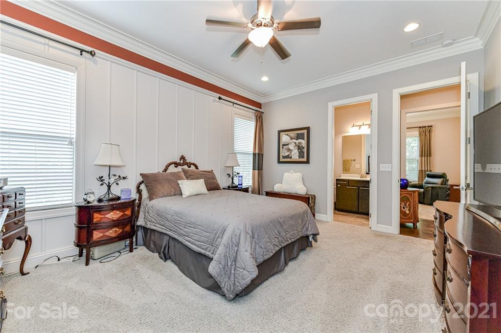 2756 Collaroy Road Waxhaw, NC 28173 - Photo 17 of 48 a spacious bedroom with a bed and a chandelier