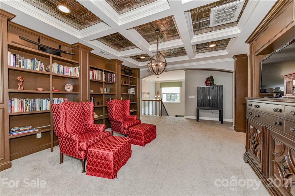 2756 Collaroy Road Waxhaw, NC 28173 - Photo 21 of 48 a living room with furniture a bookshelf and a book shelf