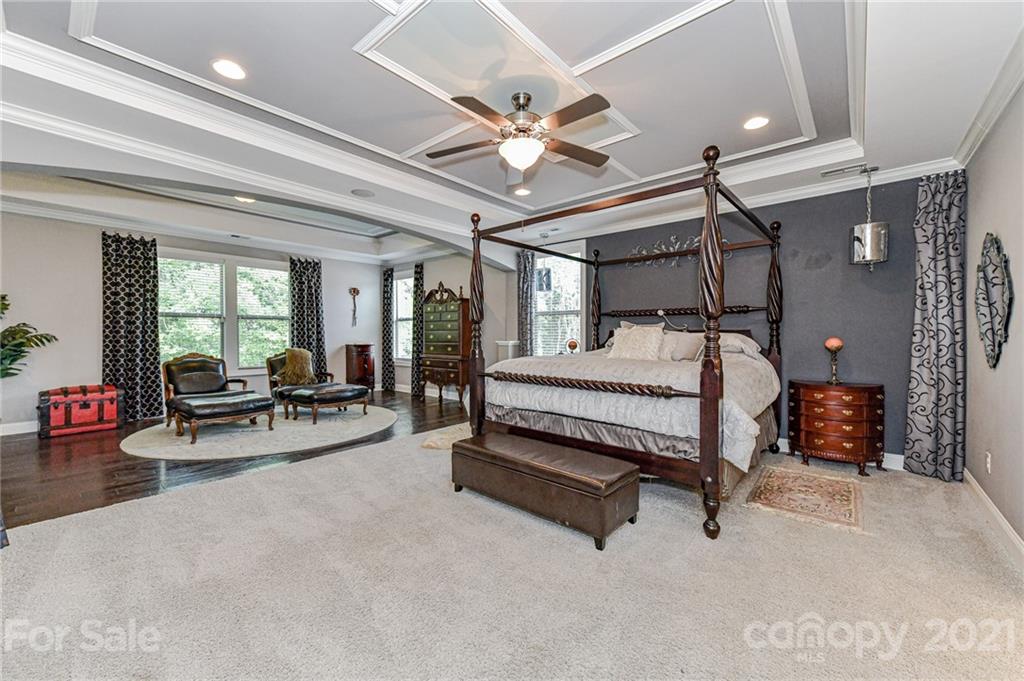 2756 Collaroy Road Waxhaw, NC 28173 - Photo 24 of 48 a bedroom with bed and a chandelier