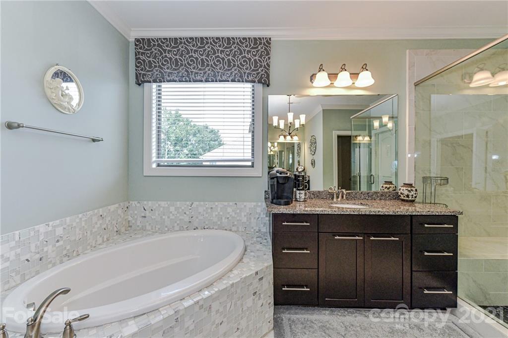 2756 Collaroy Road Waxhaw, NC 28173 - Photo 26 of 48 a spacious bathroom with a granite countertop sink and a mirror