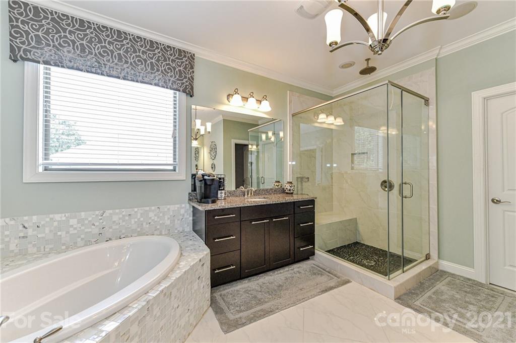 2756 Collaroy Road Waxhaw, NC 28173 - Photo 27 of 48 a spacious bathroom with a tub sink shower and mirror