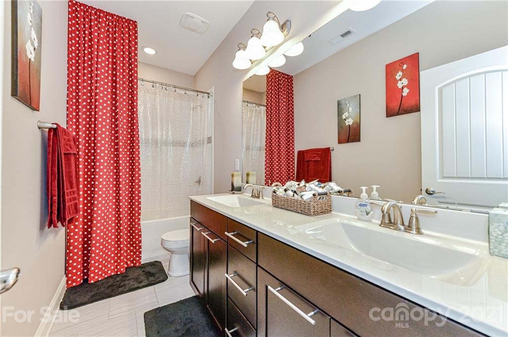 2756 Collaroy Road Waxhaw, NC 28173 - Photo 30 of 48 a bathroom with a sink vanity and a mirror