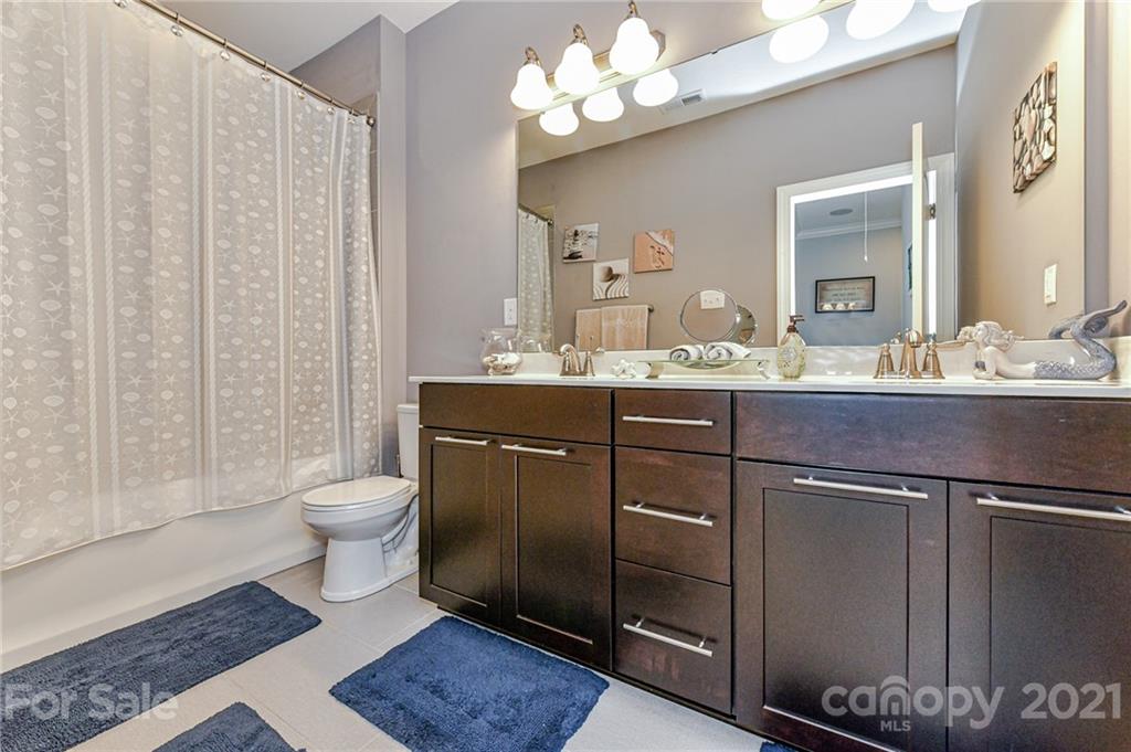 2756 Collaroy Road Waxhaw, NC 28173 - Photo 32 of 48 a bathroom with a sink a toilet and a mirror