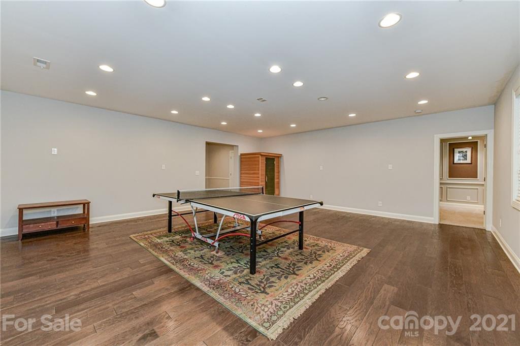 2756 Collaroy Road Waxhaw, NC 28173 - Photo 34 of 48 a living room with furniture pool table and a wooden floor