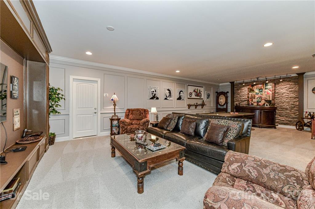 2756 Collaroy Road Waxhaw, NC 28173 - Photo 37 of 48 a living room with furniture a rug and a flat screen tv