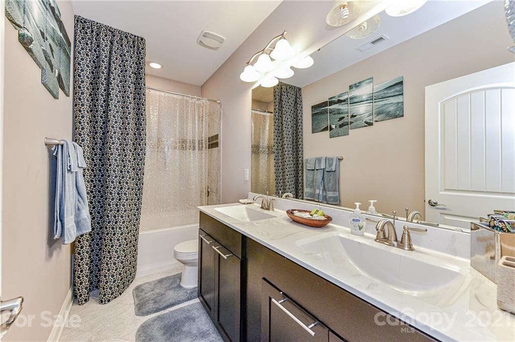 2756 Collaroy Road Waxhaw, NC 28173 - Photo 41 of 48 a bathroom with a sink double vanity and a mirror