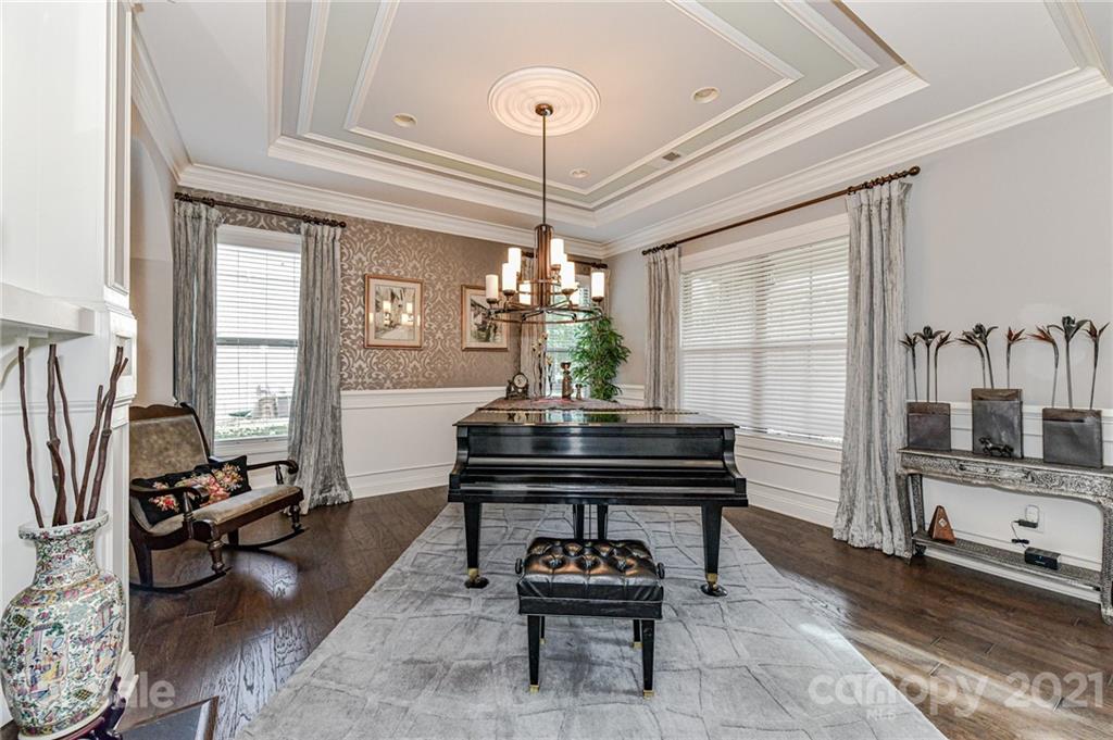 2756 Collaroy Road Waxhaw, NC 28173 - Photo 6 of 48 a living room with furniture a piano and a chandelier