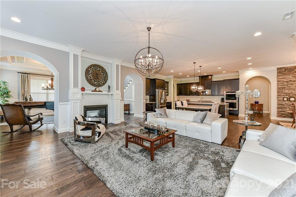 2756 Collaroy Road Waxhaw, NC 28173 - Photo 9 of 48 a living room with furniture a clock and a fireplace
