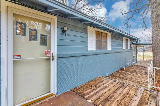 a view of backyard with a balcony and wooden floor