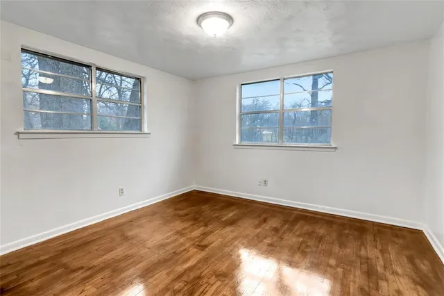 a view of an empty room and wooden floor