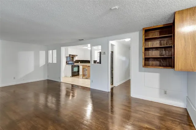 a view of a kitchen with wooden floor and a kitchen