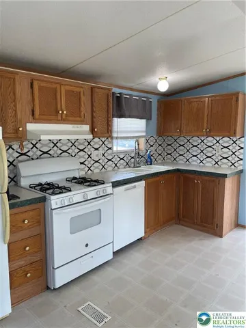 a kitchen with granite countertop a stove and a sink