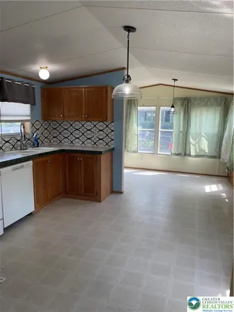 a kitchen with stainless steel appliances granite countertop a sink and a stove