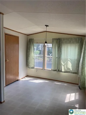 an empty room with windows and entrance