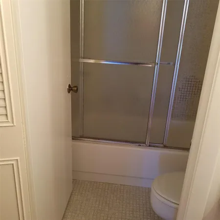 a bathroom with a shower and a sink