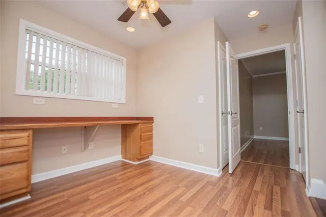 a view of a wooden balcony and trees
