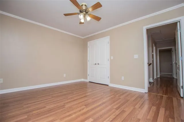 an aerial view of a house with swimming pool and large trees