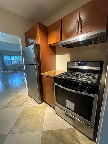 a stove top oven sitting inside of a kitchen