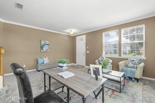 a view of a dining room with furniture window and outside view