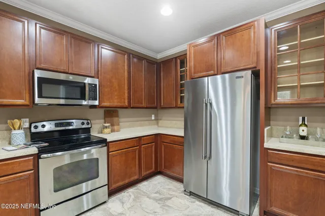 a kitchen with a refrigerator sink and microwave