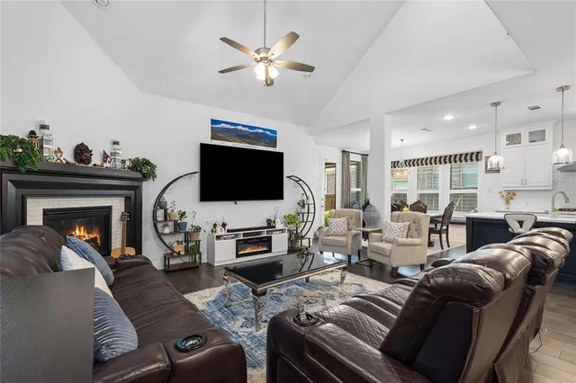 a living room with furniture fireplace and a flat screen tv