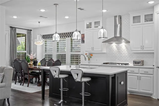 a kitchen with a table chairs stove and cabinets