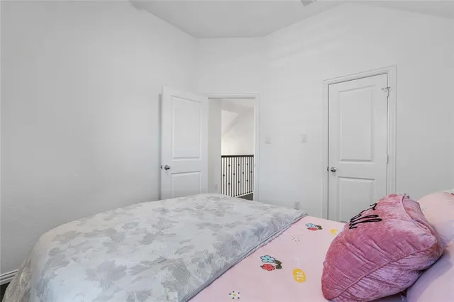 a bedroom with a bed and hallway