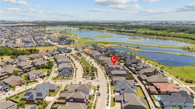 an aerial view of residential houses with outdoor space and swimming pool
