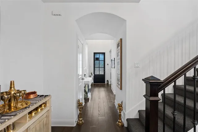 a view of a hallway with workspace and wooden floor