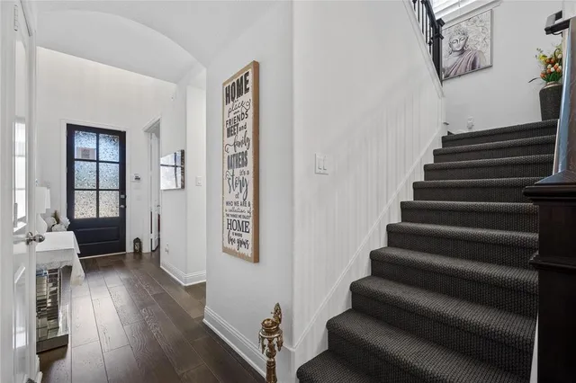 a view of entryway and hall with wooden floor