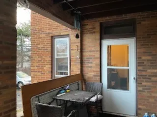 a view of a balcony with table and chairs