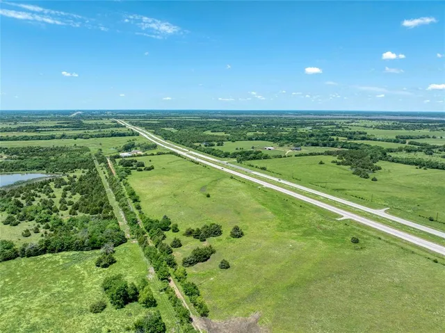 a view of a field with an ocean