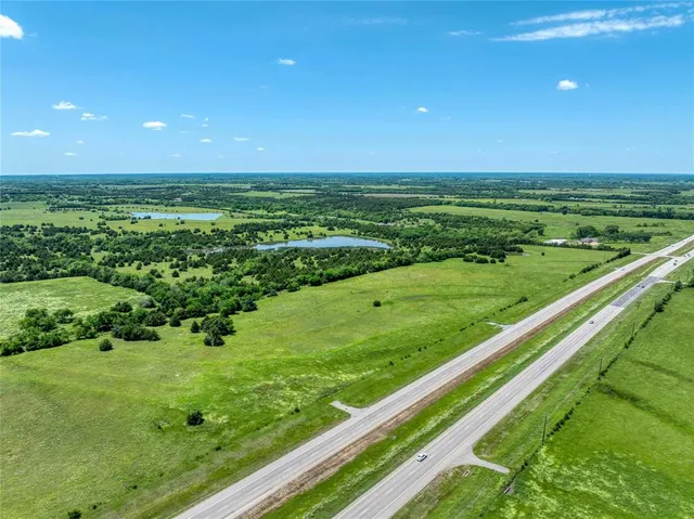 a view of a green field with an ocean view