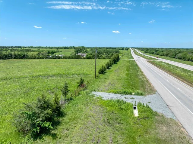 a view of a green field with an ocean view