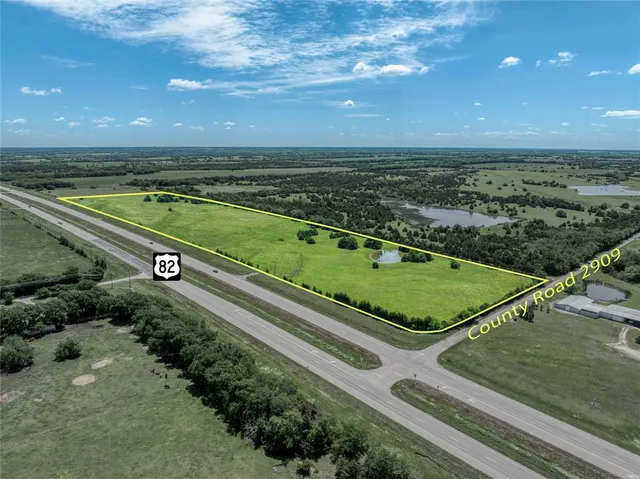 a view of a city street with a yard