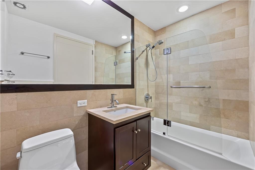 71 Village Road North, Unit 3E Brooklyn, NY 11223 - Photo 14 of 20 a bathroom with a sink a toilet and a bathtub