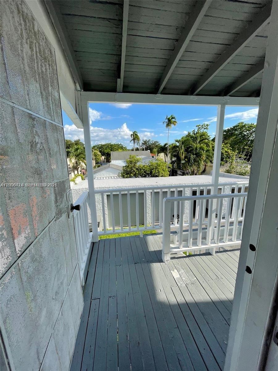 3364 Southwest 2nd Street, Unit 4 Miami, FL 33135 - Photo 12 of 14 a view of a balcony with wooden floor