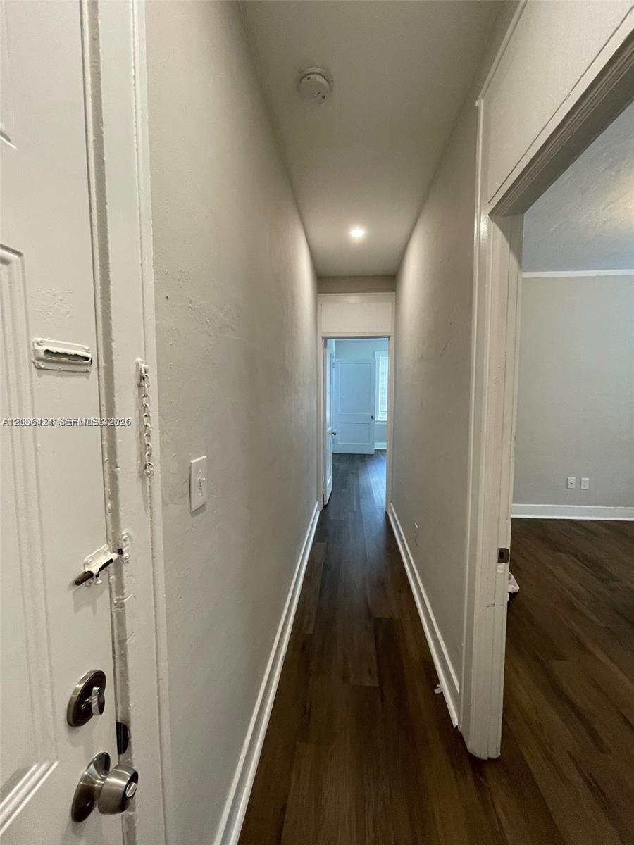 3364 Southwest 2nd Street, Unit 4 Miami, FL 33135 - Photo 5 of 14 a view of a hallway with wooden floor and staircase