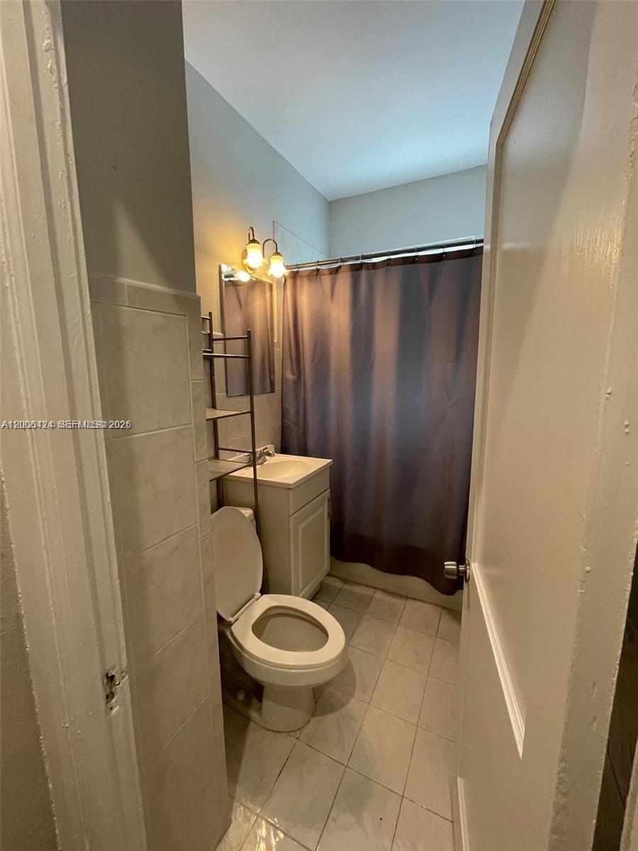 3364 Southwest 2nd Street, Unit 4 Miami, FL 33135 - Photo 7 of 14 a bathroom with a toilet and a shower
