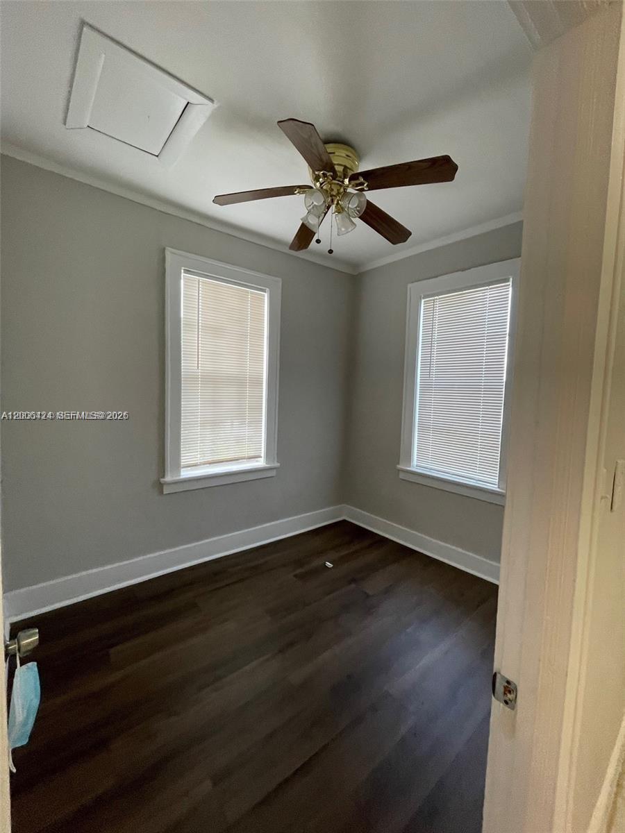 3364 Southwest 2nd Street, Unit 4 Miami, FL 33135 - Photo 9 of 14 a view of an empty room with wooden floor and a window