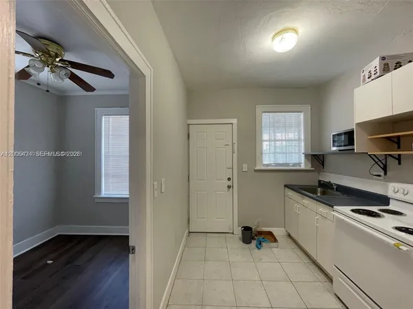 a kitchen with stainless steel appliances granite countertop a sink and wooden cabinets