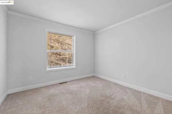 a view of an empty room and glass door