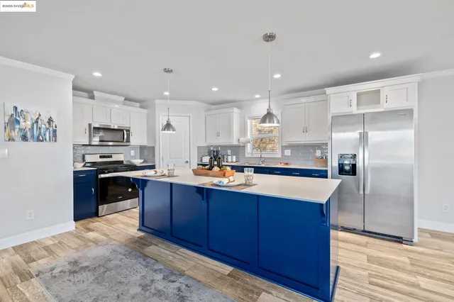 a kitchen with granite countertop stainless steel appliances and wooden cabinets