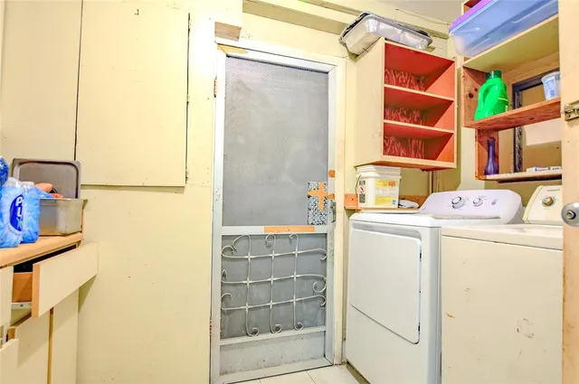 a bedroom with a bed and dresser with mirror