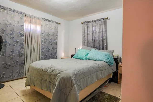 a bed sitting in a room next to a window