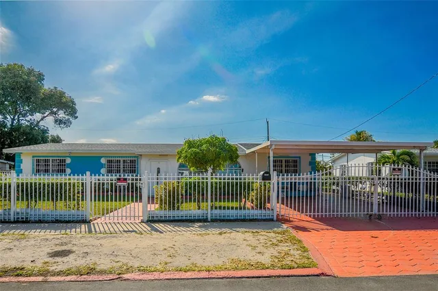 a view of a house with a wooden deck