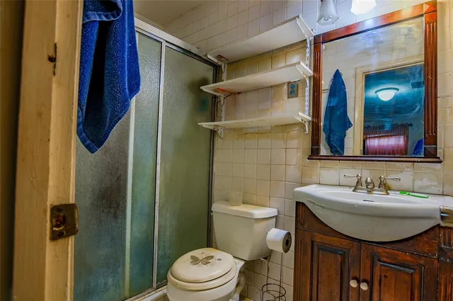 a view of a backyard patio with table and chairs under an umbrella