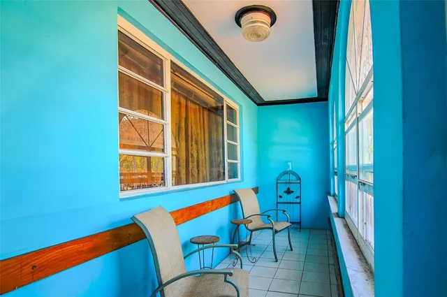an outdoor living room with furniture and a window