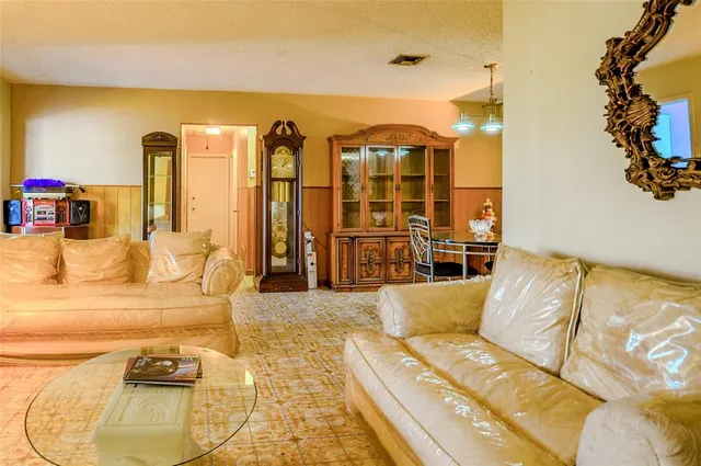 a view of living room with furniture and a large window